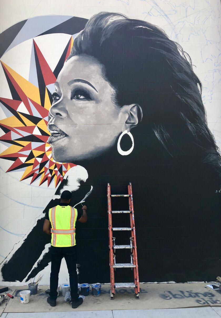 Shawn Michael Warren, who grew up on the South Side, was among the artists to complete a mural at 855 W. Madison St. Oprah Winfrey is the focus of the work.
