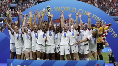 The United States’ team celebrates with the trophy after winning the Women’s World Cup final in 2019. The U.S. Soccer Federation agreed to landmark collective bargaining agreements with its men’s and women’s teams, equalizing compensation for the first time.