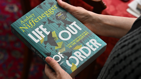 Author Audrey Niffenegger holds a copy of her new book, Life Out of Order, inside her home in the Irving Park neighborhood of Chicago on Sept. 17, 2026.