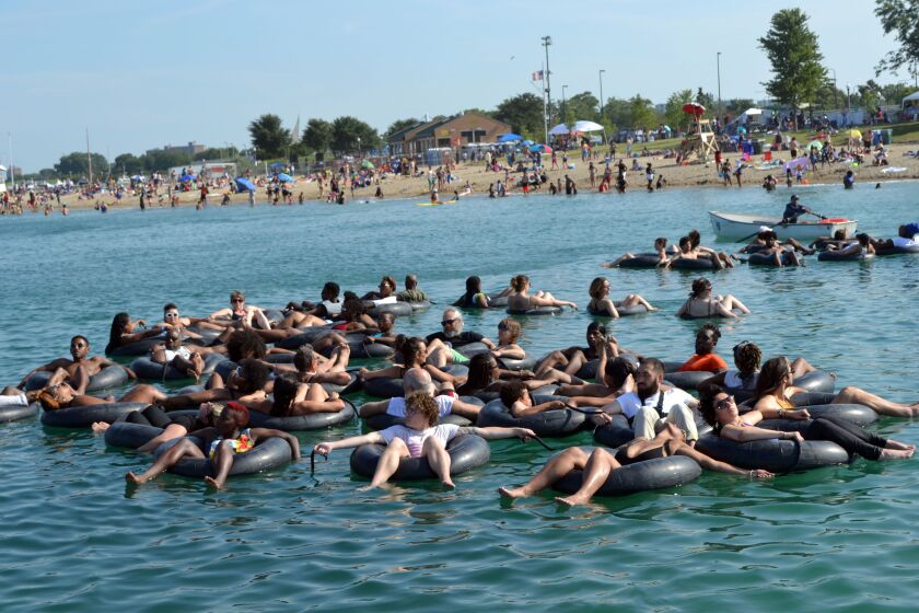 People float Saturday, July 27, 2019 in Lake Michigan at 31st St Beach to commemorate the 100 year anniversary of the 1919 race riots.