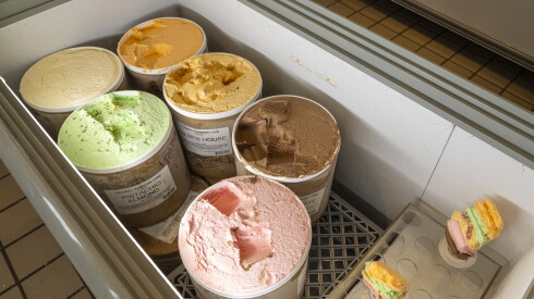 Gallons of ice cream waiting to be scooped onto a Rainbow Cone.