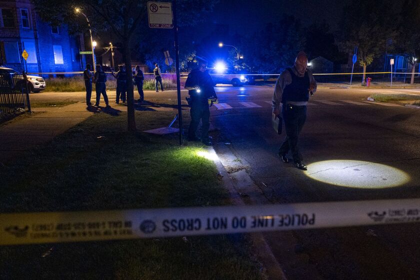Chicago police work the scene where two people were shot including a 16-year-old girl who is in critical condition, in the Lawndale neighborhood, Sunday, June 13, 2021. A 46-year-old man was also wounded.