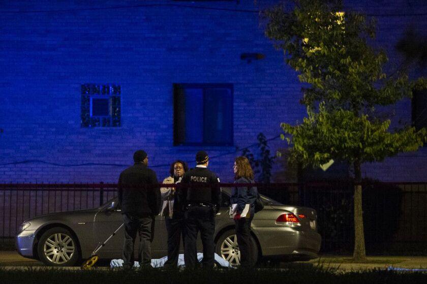 Police investigate the scene of a fatal hit-and-run, Tuesday morning in the 7900 block of South Cottage Grove. The victim was stuck on 79th and Cottage Grove and his body was dragged to 79th and Dobson. | Tyler LaRiviere/Sun-Times
