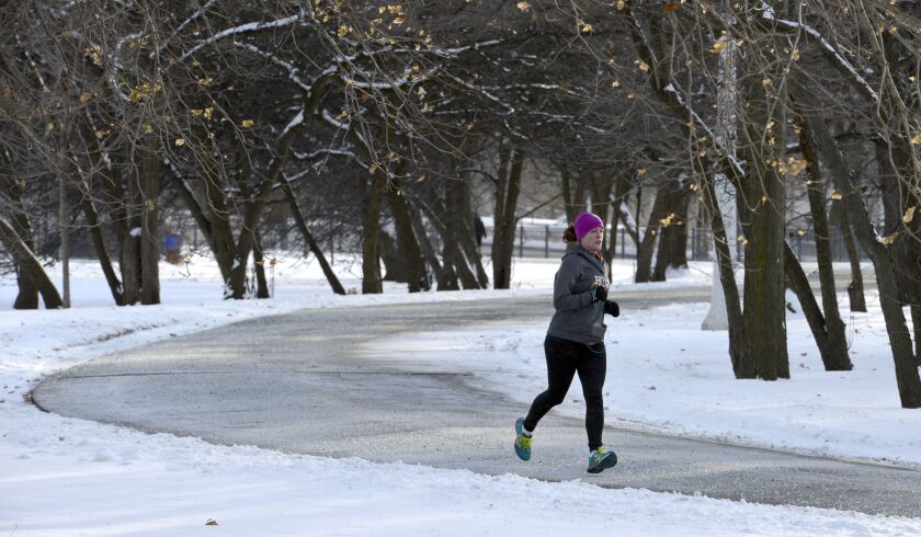 Megan Culbertson runs on the lakefront path near Lawrence and Lake Shore Drive on Tuesday afternoon. “I had an urge to get outside,” she said. “Running is warmer than walking.” She was planning to run 3 miles. Next time, she says she’s going to get a bala