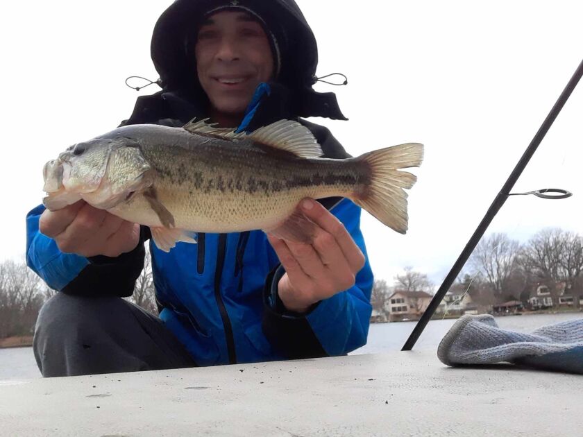 Rob Abouchar with a largemouth bass from the frigid water of Island Lake. Provided photo