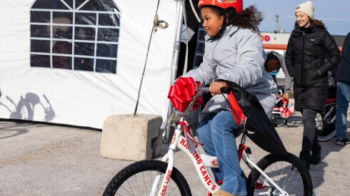 Penelope rides her new bike donated by Chance the Rapper’s nonprofit, SocialWorks, in partnership with Raising Cane’s on the Far South Side, Monday, Dec. 15, 2025.