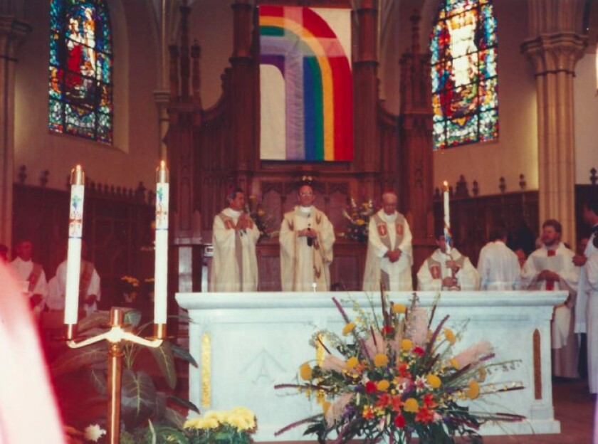 The rainbow-cross banner is pictured on display during a 1991 Mass at Resurrection Parish. | Provided photo