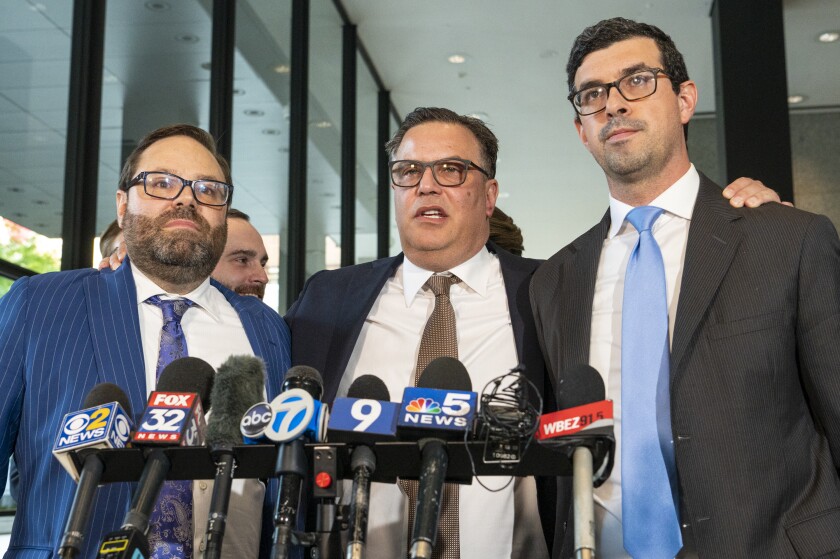 Derrel McDavid, Center, Grabs the Shoulders of His Attorneys Beau Brindley, Left, and Nadim Glozman, right as McDavid Speaks to Reporters after the R. Kelly Verdict was announed at the Dirksen Federal Courtethouse in wednesday, septa. 14, 2022 .. | PASCIAK TIPER LARVIER/SUN-TIMES
