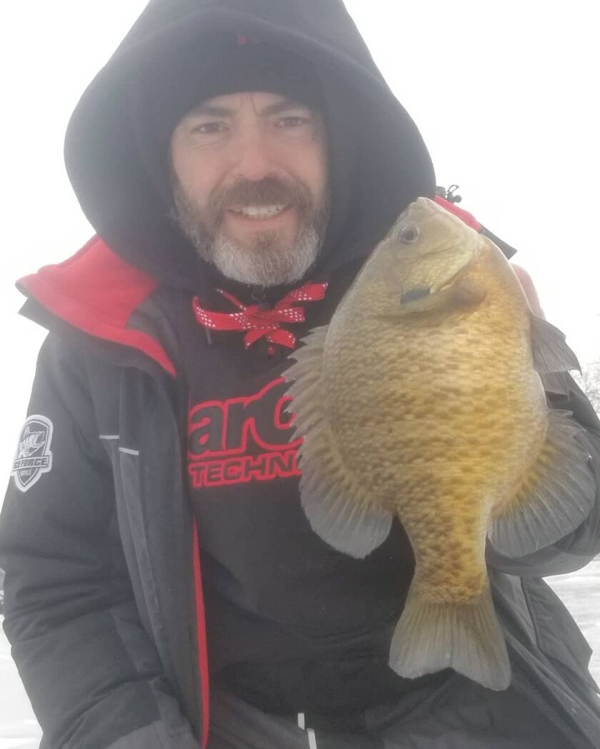 File photo of Tony Boshold with a bluegill on ice. Provided