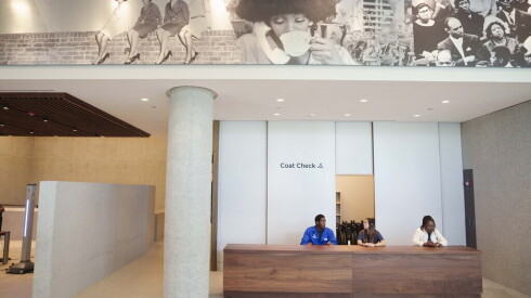 Employees work the coat check at the Obama Presidential Center.
