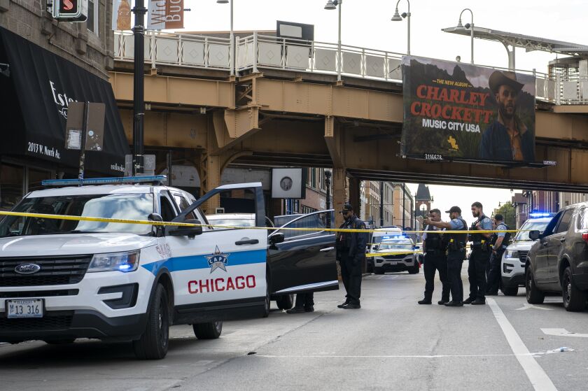 Chicago police work the scene where a 55-year-old man was shot in 2000 block of West North Avenue in the Wicker Park neighborhood, Friday, Oct. 15, 2021.