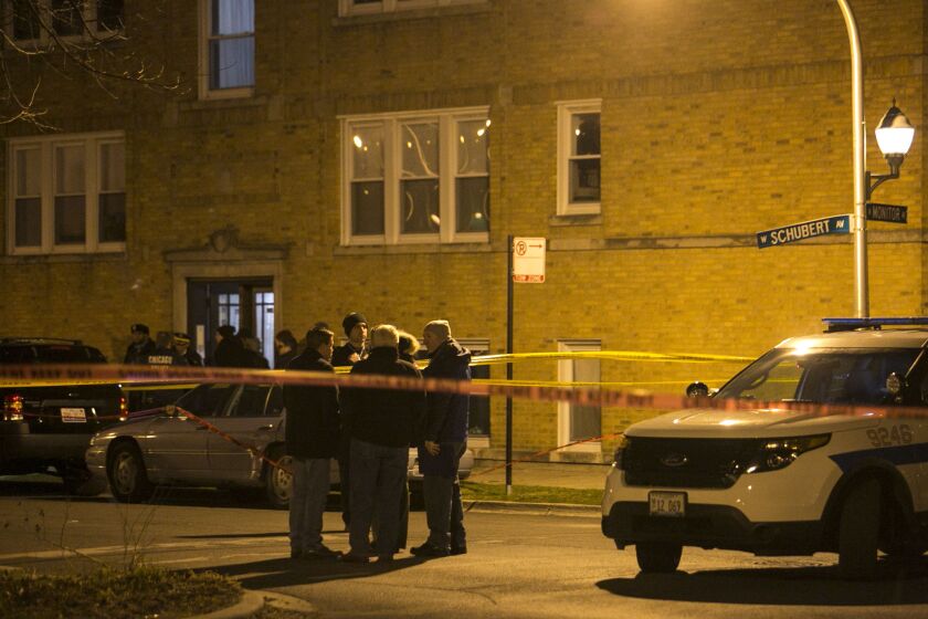 Chicago Police investigate at Schubert and Monitor avenues, where an off-duty officer shot a bat-wielding man late Saturday on the Northwest Side. | Ashlee Rezin/Sun-Times