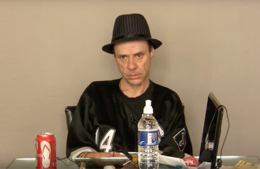 Phil Torres sitting in a chair at a desk