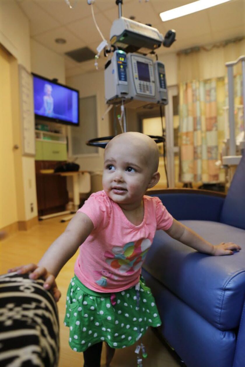 Talia Pisano stands in her room at Lurie Children’s Hospital. She’s getting tough treatment for kidney cancer that spread to her brain — and also getting a chance at having babies of her own someday despite the risks of her treatment. AP photo