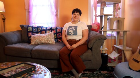 Isabel Conde sits on her couch on Saturday, April 27, 2026, at her apartment in Pilsen. Conde took in the kids in November until their mom was released at the beginning of February. | Anastasia Busby/For the Sun-Times
