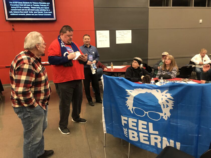 Steve Wehling, a precinct captain for Bernie Sanders, counts his preference cards in Clinton, Iowa.