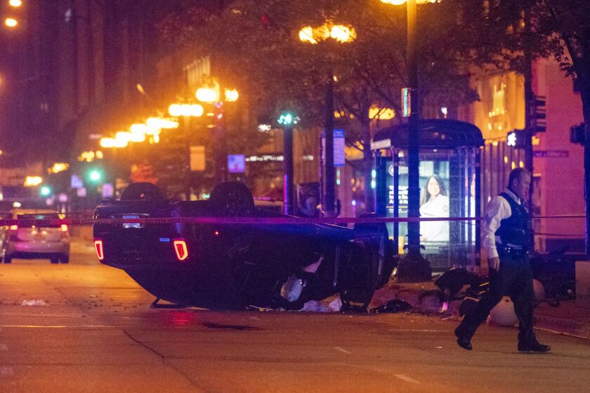 Chicago police investigate a scene where four people were shot Monday morning in the 500 block of South Michigan Avenue. | Tyler LaRiviere/Sun-Times