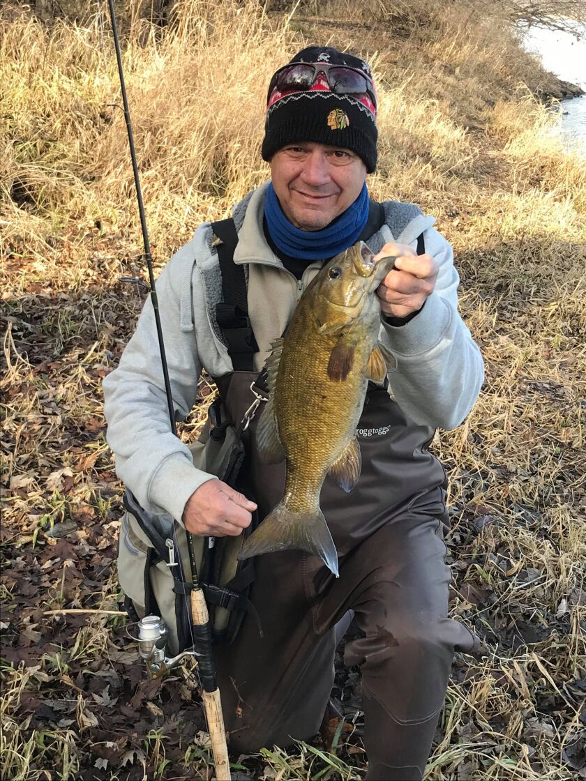 Matt Mullady with a smallmouth bass caught on artificials from the Kankakee last week.<br>Provided