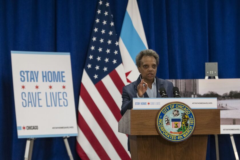 Mayor Lori Lightfoot speaks to reporters Thursday about her decision to close the Lakefront Trail, the downtown Riverwalk and other major public gathering places amid the coronavirus pandemic.
