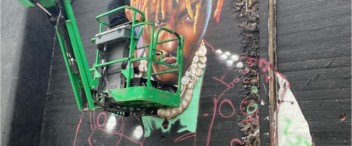 Corey Pane working on his Juice WRLD mural on Hubbard Street in July.