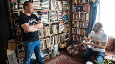 (From left) Brian Emerick and Aadam Jacobs talk in Aadam’s home, Friday, April 24, 2026. | Zubaer Khan/Sun-Times