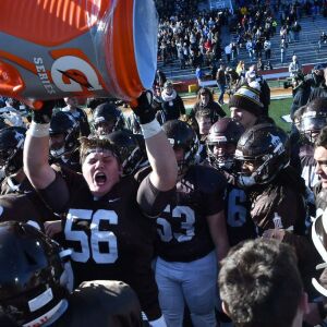 Joliet Catholic’s Colin Cox (56) dumps water on the coach. Worsom Robinson/For the Sun-Times.
