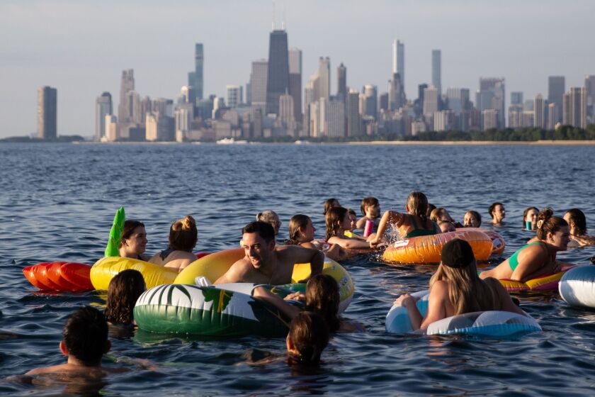 Thousands swim in Lake Michigan during Friday Morning Swim Club at Montrose Harbor on Friday, Aug. 4, 2023.
