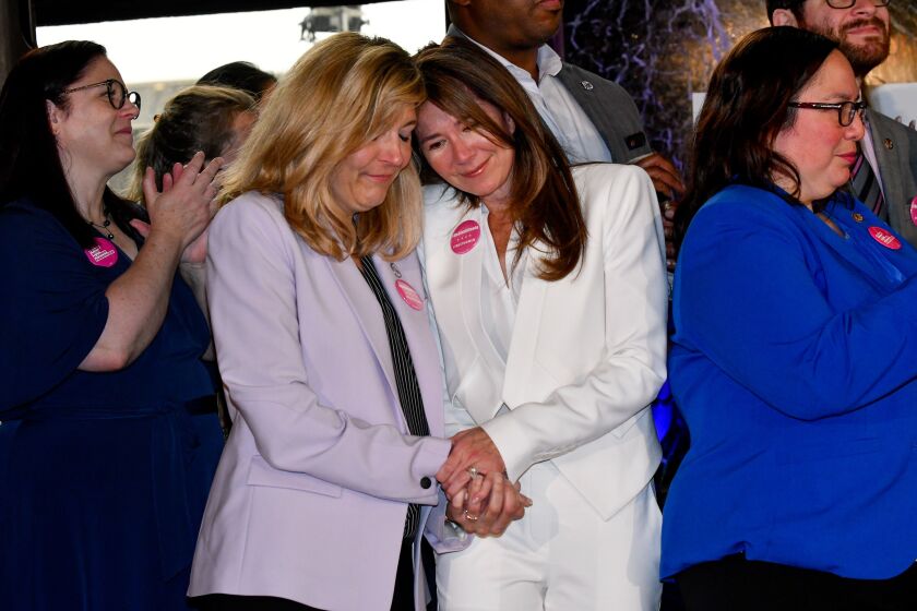 Supporters react as Gov. J.B. Pritzker signs the Reproductive Health Act during a ceremony at the Chicago Cultural Center.