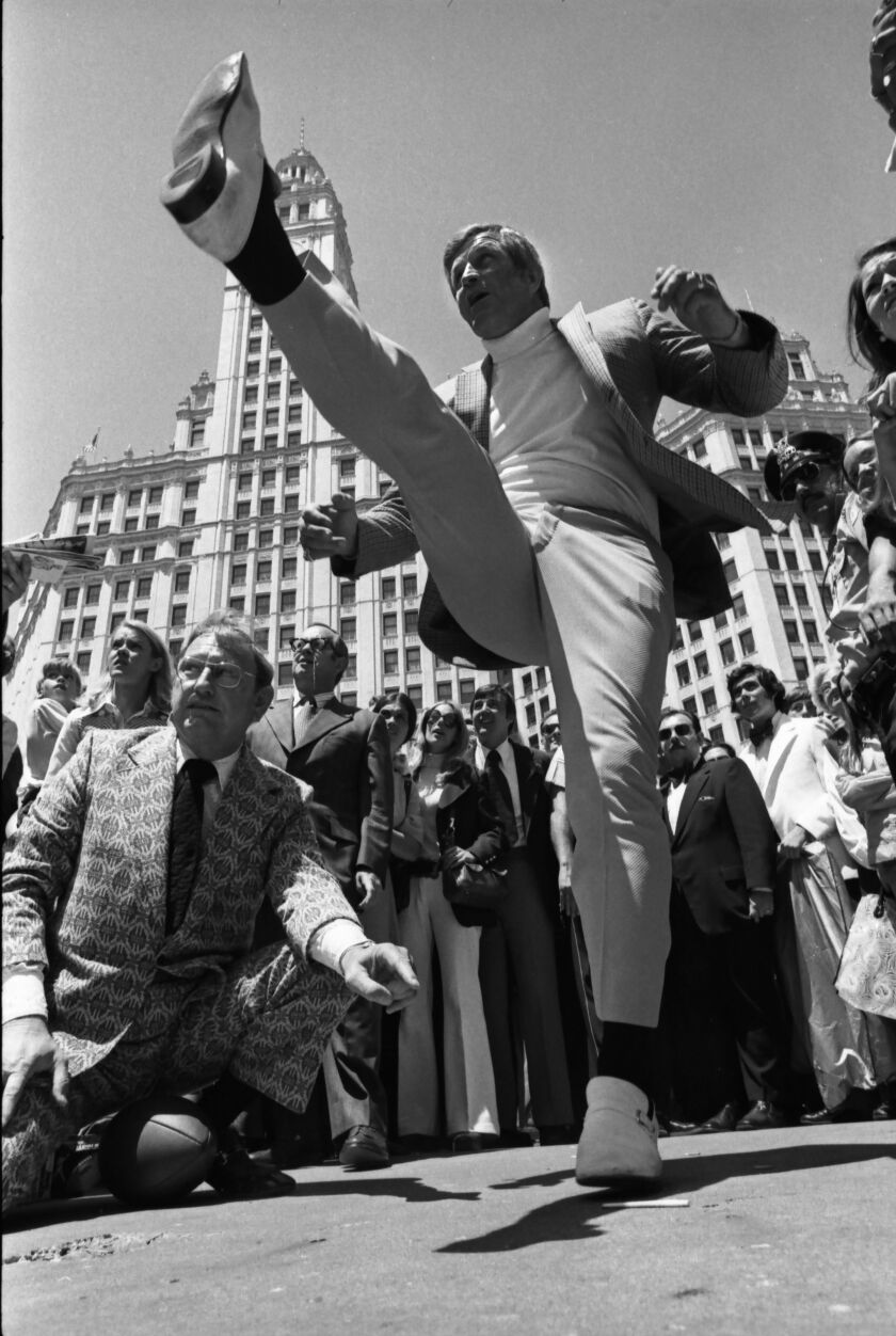 Former Chicago Bears star, the late George Blanda, tries to kick a football across the Chicago River in 1973 for a publicity stunt. Blanda plopped eight footballs into the middle of the 100-yards-wide river. “At midseason, 18 years ago, I could have done it,” said the old kicker. Photograph was taken by Jerry Tomaselli for the Sun-Times