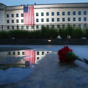 A U.S. flag is unfurled at sunrise on Tuesday, Sept. 11, 2018, at the Pentagon on the 17th anniversary of the Sept. 11, 2001, terrorist attacks. | AP Photo