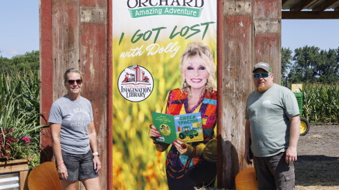 Annette Jenkins (left) and Dan Weckerly stand in front of the entrance to the Dolly Parton corn maze at All Seasons Orchard at 14510 IL-Rte 176 in Woodstock, Thursday, Aug. 27, 2026.