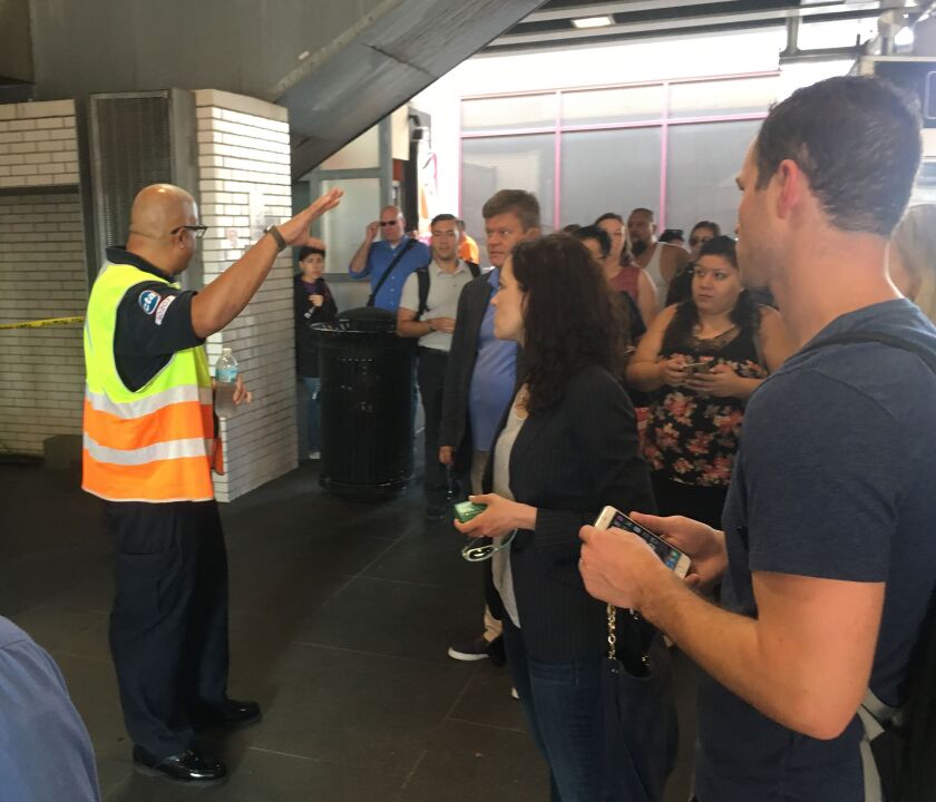 CTA employee explains re-route to confused commuters at the Fullerton CTA station. | Mitch Dudek/Sun-Times