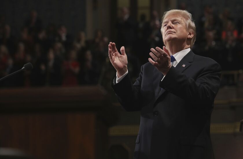 President Donald Trump claps at his first State of the Union address in the House chamber of the U.S. Capitol to a joint session of Congress on Tuesday. | AP photo