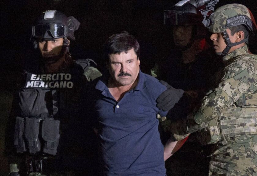 Mexican drug lord Joaquin “El Chapo” Guzman is escorted by soldiers to a waiting helicopter at a federal hangar in Mexico City on Jan. 8, 2016, after he was recaptured from breaking out of a maximum security prison in Mexico. | Rebecca Blackwell/AP
