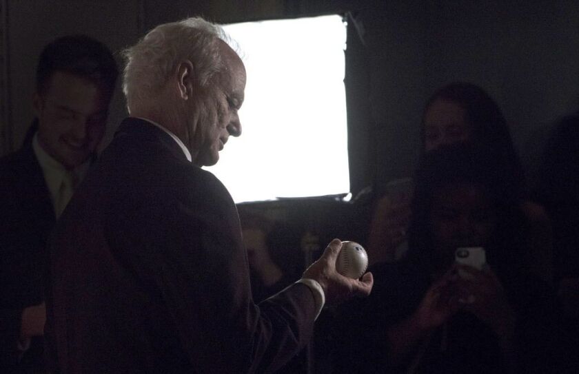 Perhaps as an homage to his beloved World Series-bound Chicago Cubs, Bill Murray holds a baseball as he arrives at The Kennedy Center Sunday night. (Photo by Leigh Vogel/Getty Images)