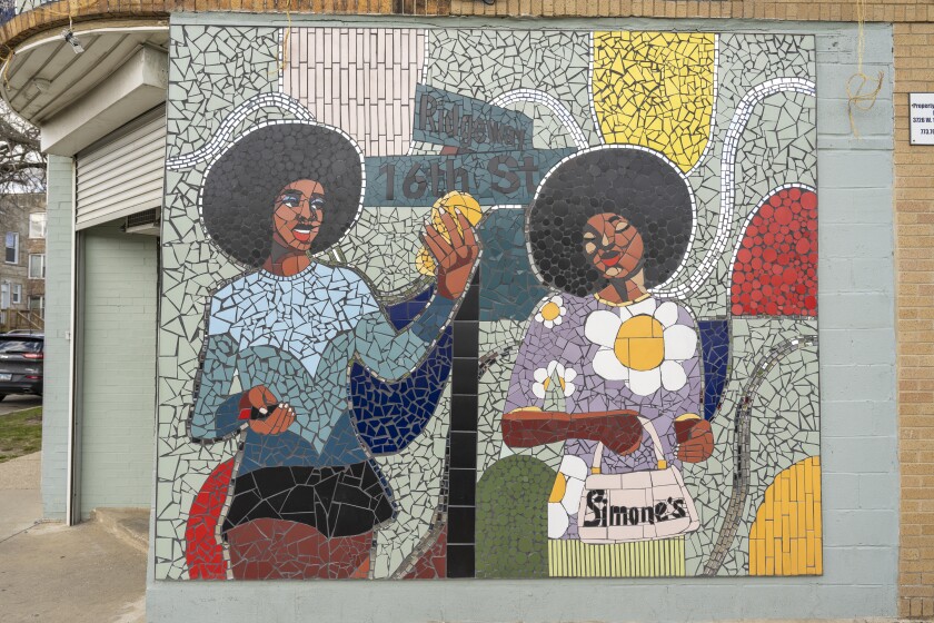 Part of the mosaic that shows a woman with a handbag reading “Simone’s,” which was a shop nearby.
