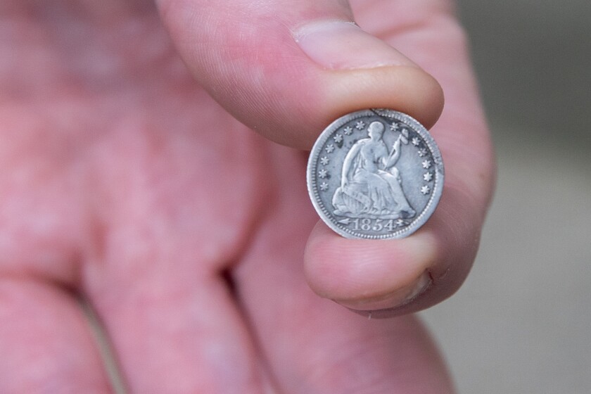 Jon Martin Holds A Seated Liberty Half of Dime Coin From 1854, in Rogers Park, on Friday, Aug. 29, 2025 .. | Zubaer Khan/Sun-Time