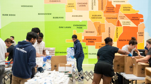 Volunteers help pack food in an assembly line-fashion at the Greater Chicago Food Depository’s warehouse in Archer Heights, Friday, Sept. 11, 2026.
