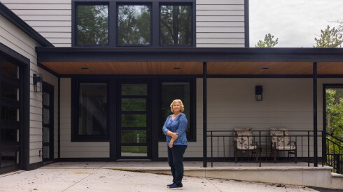 Violeta Burokas outside her two-story passive home in the Indiana Dunes. The property is Phius-certified, meaning it reduces heating and cooling energy consumption by up to 90% compared to a traditional home.