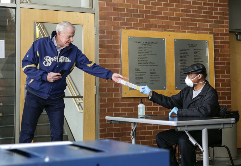 Milwaukee Mayor Tom Barrett gets help with his ballot on Saturday.