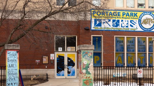 A brick school displays signs that say "Panthers" and "Portage Park."