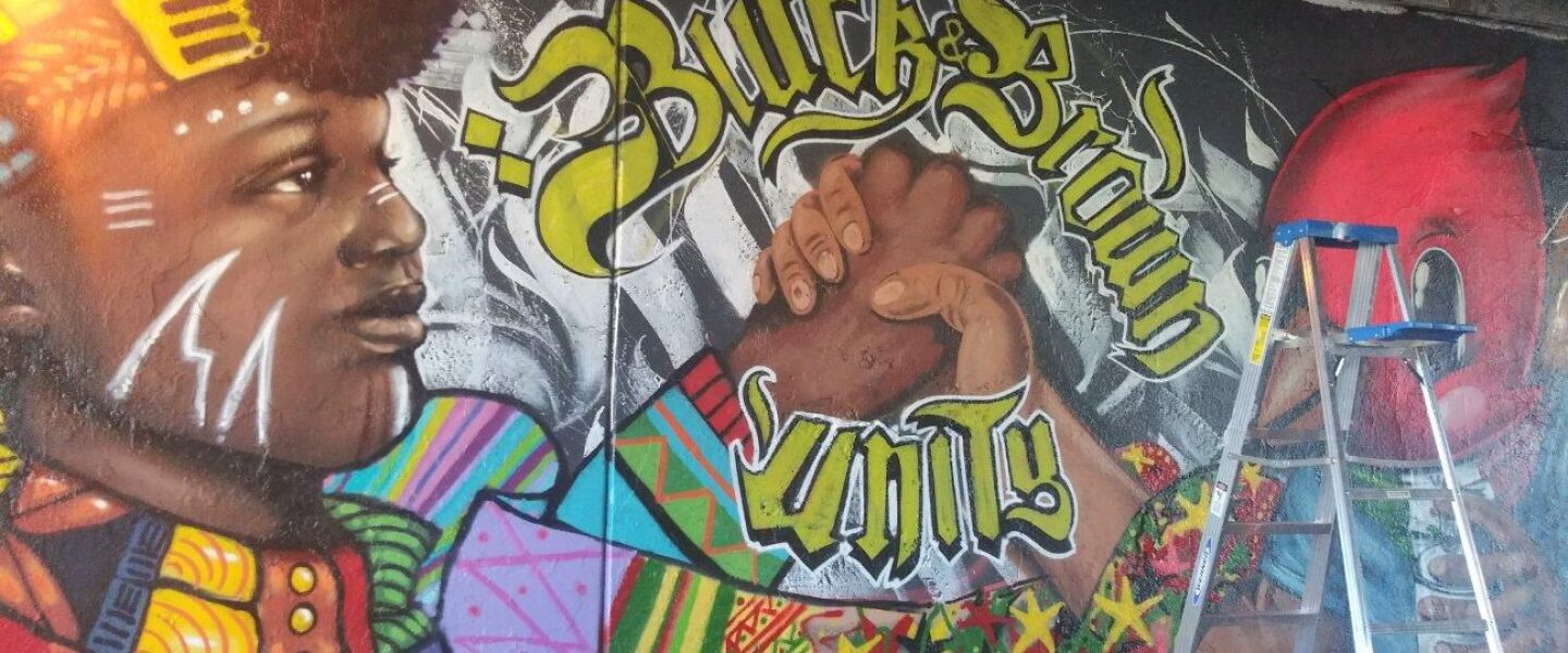 A street artist who goes by the name “Dred Ske” worked on the original “Black and Brown Unity” mural in Pilsen before it was covered over with white paint.