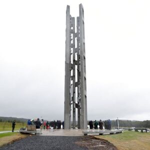 People attending the dedication stand around the 93-foot tall Tower of Voices at the Flight 93 National Memorial in Shanksville, Pa., where the tower contains 40 wind chimes representing the 40 people who perished in the crash of Flight 93 in the terroris