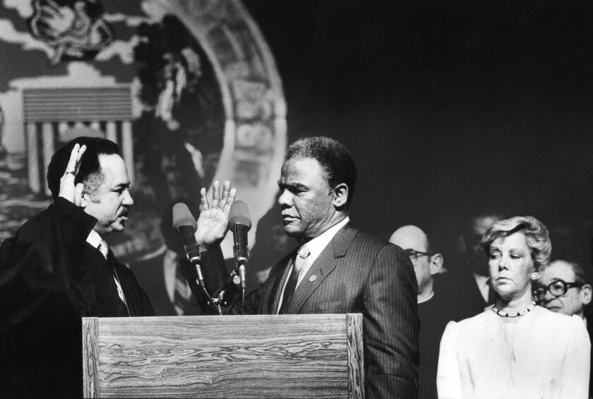 Cook County Circuit Judge Charles E. Freeman swears in Harold Washington as Chicago s 42nd mayor at Navy Pier on April 29, 1983. Outgoing Mayor Jane Byrne is at right Historic moment. | Sun-Times Library