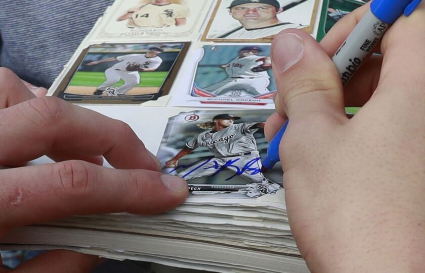 <em>Michael Kopech signs an autograph for a fan.</em>
