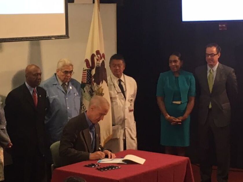 Gov. Bruce Rauner signs the organ donation bill Tuesday. Provided photo.