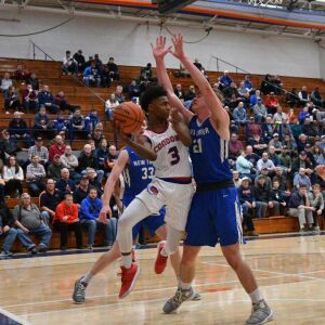 Curie’s DaJuan Gordon (3) passes the ball back out, Friday 12-28-18. Worsom Robinson/For Sun-Times