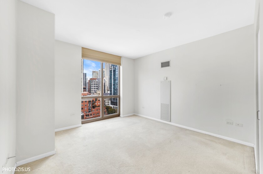 Interior of one of the bedrooms with floor-to-ceiling window