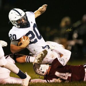 Cary-Grove’s Blake Skol (20) fights for every yard. Allen Cunningham/For the Sun-Times.