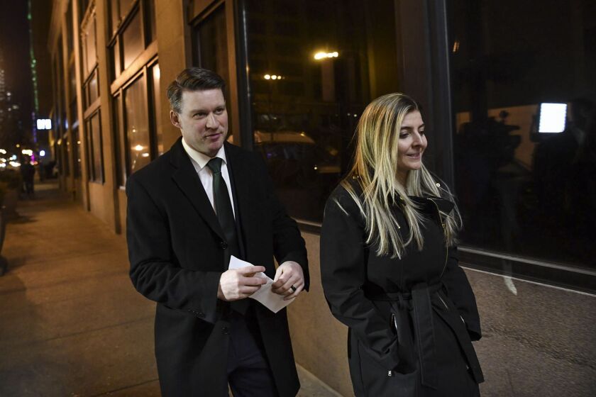 Bill Conway, left, and his wife, Brittany, walk to his campaign office Tuesday